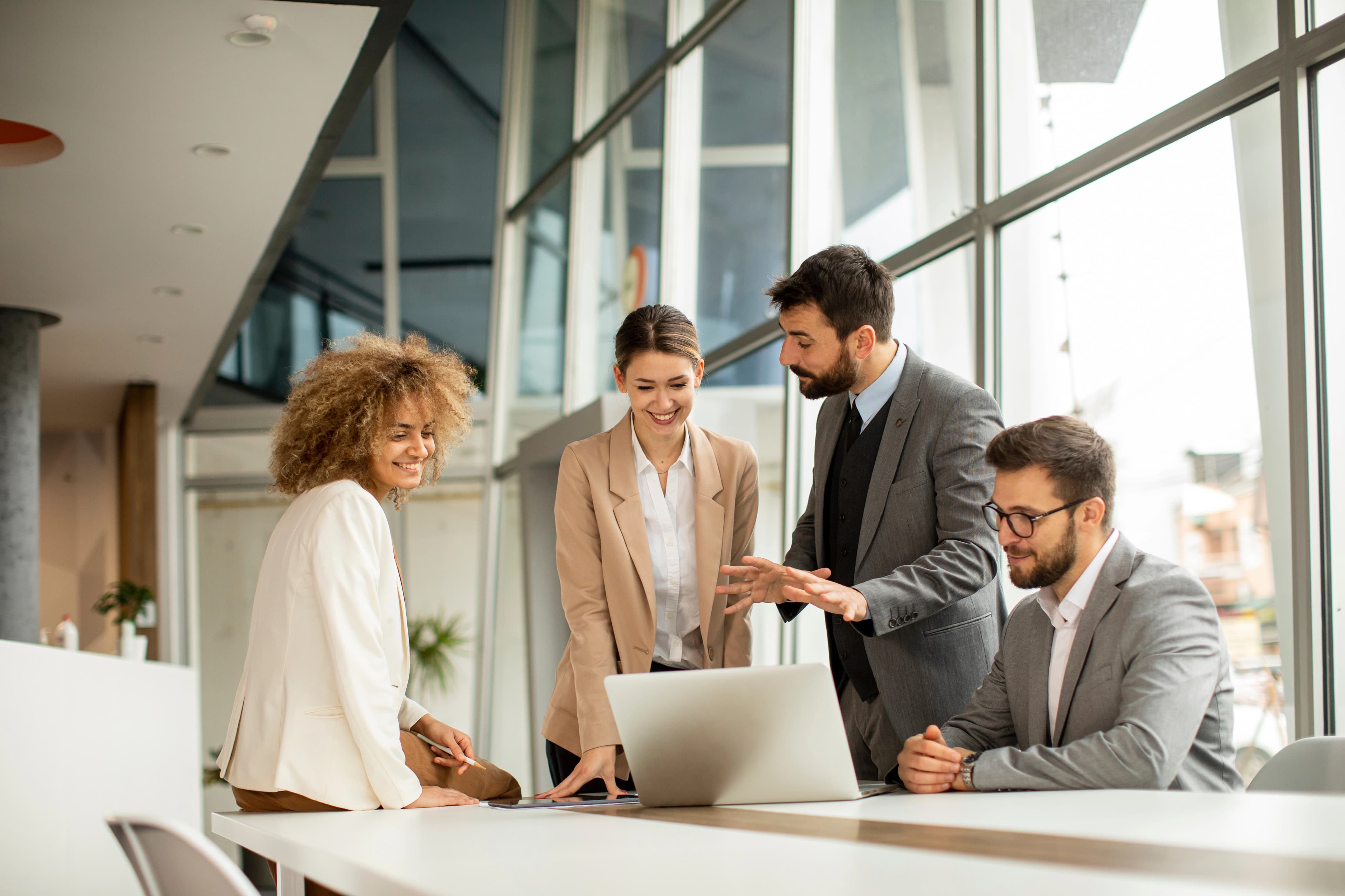 Hero image of a group of people discussing a project in an office